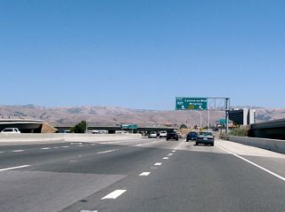The left three lanes depart California 237 and transition to Interstate 880. (This is Exit 9B, Interstate 880 (Nimitz Freeway) north to Oakland and Exit 9C, Interstate 880 (Nimitz Freeway) south to San Jose). The right two lanes continue east on California 237 (Calaveras Boulevard); the freeway will soon come to an end.