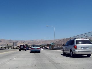 After the traffic signal with the off-ramp from Interstate 880 south, eastbound California 237 crosses over Interstate 880 (Nimitz Freeway), a loop ramp offers a third connection to Interstate 880 north (right exit).