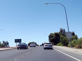 A ramp connects westbound California 237 to Main Street (unsigned Exit 10) beyond the bridge spanning the Union Pacific Railroad.