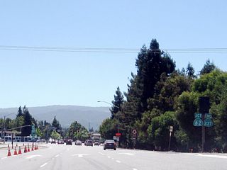 Westbound California 237 (Mountain View-Alviso Road) comes to an end as the freeway approaches California 82 (El Camino Real) at the traffic signal ahead.