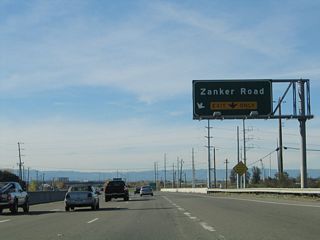 After the on-ramp from McCarthy Boulevard, the right lane becomes exit only for Exit 8, Zanker Road. Ahead, California 237 crosses Coyote Creek and departs the city of Milpitas and enters the city of San Jose, which is home to 894,943 people as of the 2000 Census. Founded on November 29, 1777, and incorporated on March 27, 1850, San Jose is the third largest city in California (behind Los Angeles and San Diego). San Jose consists of 178.2 square miles and sits at an elevation of 85 feet. Rainfall in San Jose is much less than San Francisco due to its location at the south end of the San Francisco Bay and enclosure within mountains. The average annual precipitation is 14.4 inches.