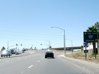After the Abel Street, Serra Way, and Abbott Avenue traffic signals, westbound California 237 approaches Interstate 880 (Nimitz Freeway). The first ramp (Exit 9C) connects to Interstate 880 north to Oakland. The next exit is a loop ramp to Interstate 880 south to San Jose.