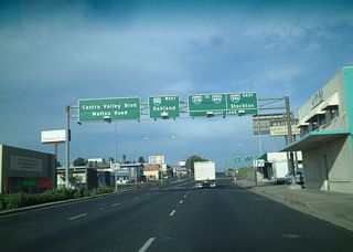 California 238 leaves Hayward as a surface street and promptly assumes a freeway configuration upon leaving the downtown area. As noted on this overhead sign, this is the first indication that what once was California 238 is now Interstate 238, and traffic must stay right to remain on that highway.  An Interstate 880 shield almost always accompanies signage for Interstate 238, since that is the primary destination for travelers on northbound Interstate 238. Other options are to eastbound Interstate 580 toward Dublin (junction with Interstate 680) and westbound Interstate 580 (which actually heads northwesterly from here) to Oakland. Through traffic in the left lane defaults onto a connector ramp to Castro Valley Road and Mattox Boulevard.