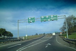 After the ramp to Castro Valley Road and Mattox Boulevard exit left, this sign greets motorists with a choice between Interstate 580 westbound and Interstate 238 northbound/Interstate 580 eastbound. Through traffic on Interstate 238 must remain in the right lane. Note the use of Stockton as the control city for Interstate 580, rather than Livermore or Tracy.