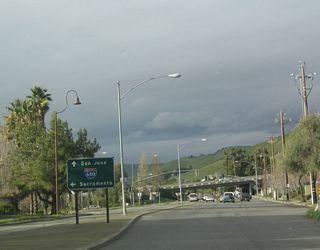 Northbound Mission Boulevard approaches Interstate 680 in the Mission San Jose neighborhood of the city of Fremont. At this interchange, Mission Boulevard becomes part of California 238 north to Union City and Hayward. A park and ride is situated on the east side of Mission Boulevard. The first turn is to Interstate 680 north to Sacramento at the traffic signal.