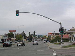 Northbound California 238 (Mission Boulevard) meets Fletcher Lane at this signalized intersection. The Five Corners intersection can be seen in the distance; a left turn onto California 92 is not permitted at this intersection.
