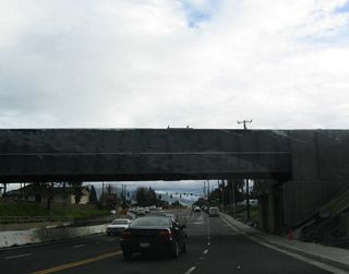 California 238 south and California 84 west pass under the Union Pacific Railroad tracks, which also pass into Niles Canyon. In the distance, the two routes divide at the Mowry Avenue traffic signal.