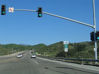 Eastbound Oso Parkway meets the off-ramp from California 241 (Foothill Transportation Corridor) south at this traffic signal. An on-ramp to California 241 north is the next left turn.