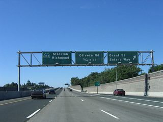 Northbound California 242 reaches Exit 2, Solano Way/Grant Street. The next exit is Exit 3A, Olivera Road, followed by Exits 3B-C, California 4. Note the pull-through sign, which at one time showed California 24 but was replaced with a California 242 shield when California 24 was retracted to its current configuration.