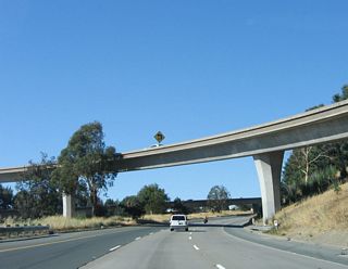 The flyover ramp for Exit 3B, California 4 west to Martinez and Hercules crosses over the three-lane transition ramp to California 4 east.