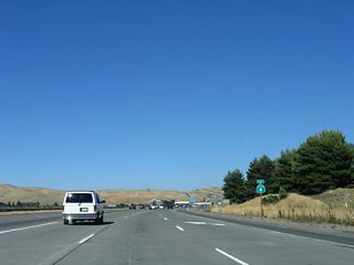 The three-lane transition ramp merges onto California 4 east, and a California 4 reassurance shield is posted there. No end California 242 shield assembly is posted here.