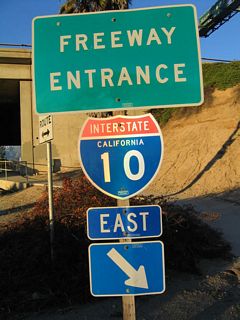 This freeway entrance shield assembly is posted on the connection from northbound California 243 to eastbound Interstate 10.