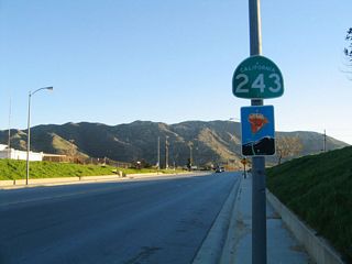 California 243 begins at Exit 100 in Banning. The state route initially follows Eighth Street south under the Union Pacific Railroad tracks and passes by this reassurance shield. All of California 243 is designated as a state scenic route.