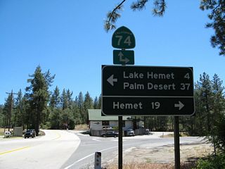 At the junction between the wye connector between California 74 and California 243, curve to the left for California 74 east to Palm Desert and Indio or turn right here for California 74 west to Hemet and Perris. The stop sign in the distance is the actual intersection with California 74.