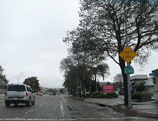 After a recent rain storm, the gutters were full of water next to a flood warning sign. A shield for California 246 is posted on Ocean Avenue after L Street in Lompoc.
