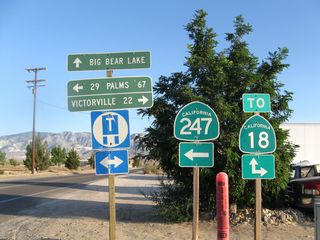 SR 247 continues east along Old Woman Springs Road toward Landers and Yucca Valley. Barstow Road extends a quarter mile south to SR 18 for Big Bear Lake. Old Woman Springs Road connects with SR 18 a quarter mile to the west for Apple Valley and Victorville.