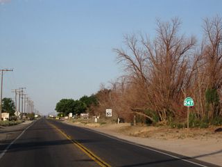 Old Woman Springs Road runs east along the section line for five miles from Barstow Road before shifting southward around the San Bernardino Mountains toward Landers and Yucca Valley. SR 247 ultimately links with SR 62 in Yucca Valley; SR 62 proceeds south to Palm Springs or east to 29 Palms.