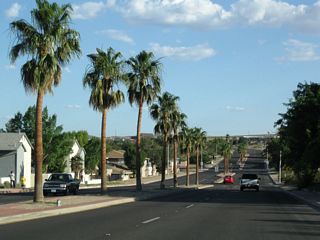 California 247 (Barstow Road) passes through a residential area with a palm-lined median.