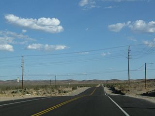 After passing under the power lines, nothing but scenic, undeveloped desert lies ahead for several miles along California 247 south. The power lines mark the southern city limits of Barstow. This is the last call for motorist services before many miles of undeveloped desert lands.