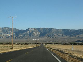 Power poles, fences and ranch houses appear along SR 247 leading into the community of Lucerne Valley. Isolated from the more populated corridor along Interstate 15, Lucerne Valley is located east of the Victor Valley and Apple Valley and west of the Johnson Valley.