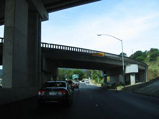 A flyover ramp carries traffic from northbound U.S. 101 (Redwood Highway) to westbound Sir Francis Drake Boulevard.