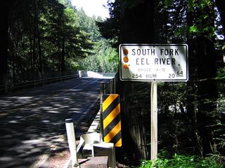 This bridge carries California 254 north over the South Fork of the Eel River at postmile 20.64. The flood of 1964 did not destroy this 1931 bridge, but it was reconstructed in 1966 to raise its height.
