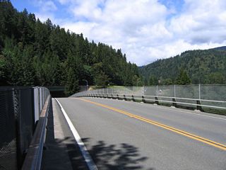 The new bridge deck looks more like a mid-1960s bridge than a 1930s bridge. The South Fork of the Eel River flows below the Avenue of the Giants.