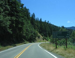 This mileage sign along southbound California 254 (Avenue of the Giants) provides the distance to Garberville (9 miles), Ukiah (99 miles), and San Francisco (208 miles).