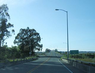 Northbound (westbound) California 255 reaches the Woodley Island marina exit ramp. Despite the interchange, California 255 remains a Super Two freeway.
