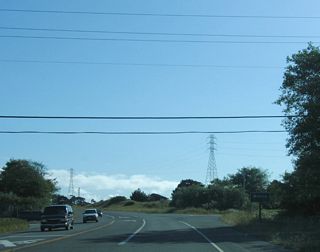 Now traveling south, California 255 passes by the Manila town limits sign. The highway through here is designed as a two-lane expressway, with access to the roadway limited to specific intersections.