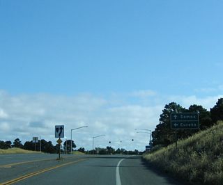 Southbound California 255 prepares to split ahead, with the state highway turning east to return to U.S. 101 and the city of Eureka, the seat of Humboldt County. To connect to the town of Samoa, continue straight ahead.