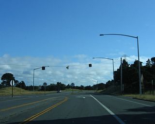 A flashing beacon governs the flow of traffic at the intersection between California 255 south (east) to Eureka and New Navy Base Road south to Samoa.