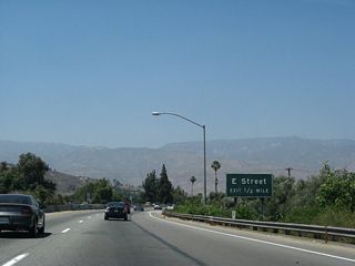 Exit 1 B joins E Street adjacent to the freeway along SR 210.
