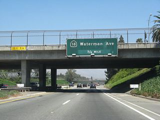 Two lanes continue east along SR 259 onto SR 210 ahead of Exit 76 to SR 18 (Waterman Avenue) north.