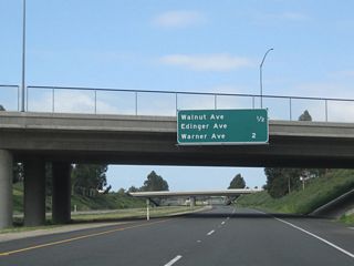 This mileage sign along California 261 south provides the distance to the next two exits: Exit 1, Walnut Avenue and Edinger Avenue and Exit 0, Warner Avenue.