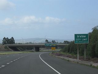 California 261 leaves unincorporated Orange County and enters the city of Irvine as it continues northeast toward Interstate 405 and Interstate 5. Irvine, which incorporated on December 28, 1971, is a master planned city that is home to the University of California at Irvine and features a variety of developments and neighborhoods. Irvine a population of 143,072 as of the 2000 Census.