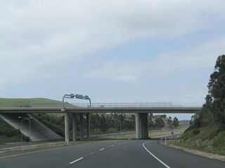 California 261 passes under Santiago Canyon Road (Orange County S-18). There is no access from California 261 to Santiago Canyon Road or Chapman Avenue on the assumption that traffic from California 241 south would have used Exit 33 on that toll road.