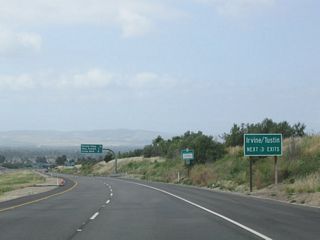 The next three exits from California 261 south (Exit 3, Portola Parkway; Exit 2, Irvine Boulevard; and Exit 1, Walnut Avenue) all serve the cities of Tustin and Irvine. California 261 will straddle the limits between the two cities from here southwest to its end after passing under Interstate 5.