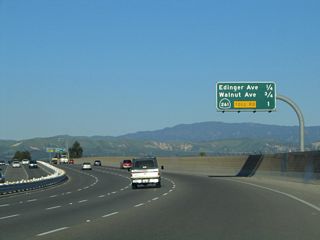 Northbound Jamboree Road transitions directly onto California 261 north in the city of Irvine. This mileage sign provides the distance to the next two exits on Jamboree Road (Edinger Avenue and Walnut Avenue) and the point where Jamboree Road connects directly with California 261 north.