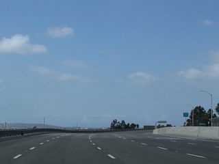 Jamboree Road briefly enters the city of Tustin ("Community Trees History Future"). Tustin incorporated in 1927, consists of 11.4 square miles, and was home to 67,504 people as of the 2000 Census. Ahead, Jamboree Road passes over Edinger Road, which is reached via the very long distributor ramp at Exit 1.