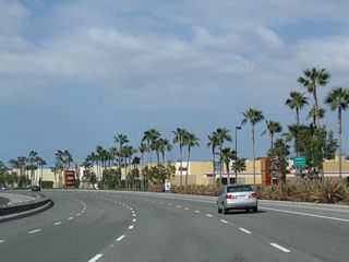 This series of photos follows Jamboree Road as it proceeds south through the Warner Avenue interchange. A new shopping center located on the Tustin side of Jamboree Road comes into view. Jamboree Road continues with four southbound lanes, then approaches a signalized intersection with Barranca Parkway. This intersection will mark the end of the freeway segment connected by both California 261 and Jamboree Road.