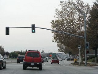 There are only two traffic signals along California 262. The first traffic signal (shown here) is with Mohave Drive, which provides access to residential and commercial areas along both sides of the state route. The traffic signal is photo-enforced with a red light camera.
