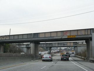 This brief section of freeway was built in the 1950s, with the two railroad overpasses built in 1953-1954 and the original Kato Road overpass built in 1958 (and replaced with the current construction project).