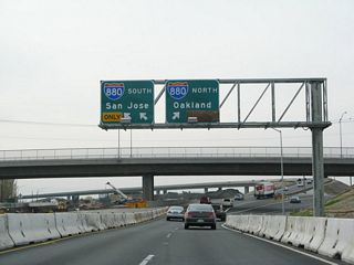 The new Kato Road overpass, which features a much wider bridge to accommodate more lanes, comes into view after passing under the two railroad bridges. The final configuration of the new California 262 becomes clearer. The right lane of westbound California 262 will provide access to Interstate 880 north to Oakland, but both lanes will offer access to Interstate 880 south to San Jose.