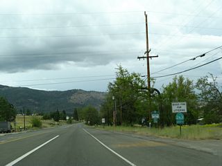 Main Street northbound in northern Yreka. California 263 leaves the intersection with Business Loop I-5 and California 3 (Montague Road) and proceeds north along Historic U.S. 99 toward the Shasta River Canyon. The business loop does not continue north of Montague Road along Main Street.