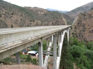 A ranch is located in the canyon below the double arch bridge.