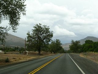 Continuing north, California 263 sees only some limited development; this view is just south of the intersection with Hawkinsville Humbug Road. This road travels northeast to provide local and ranch access.