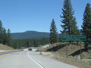 California 267 was realigned in 2002 onto a two-lane expressway bypass. Known as the CHP Officer Glenn Carlson Memorial Bypass, the expressway has ample right of way for expansion to four lanes, and it features a tall bridge over the Union Pacific Railroad, Glenshire Drive, and the Truckee River. The bypass cost $33.6 million. Construction began in August 1999, and the facility opened on October 24, 2002. The old alignment is now known solely as Brockway Road and does not carry a business designation.