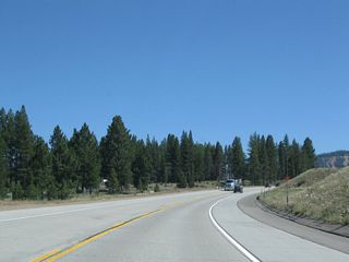 Southbound California 267 continues toward its junction with Brockway Road. In the distance, the ski runs associated with Northstar at Tahoe come into view.
