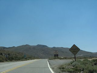 A beat-up sign warns of the end of California 270 at the point where the pavement ends. An unpaved road continues for the final distance to the state park.